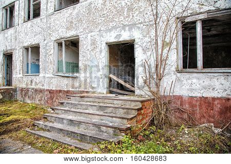 old abandoned high-rise building on gloomy cold autumn day