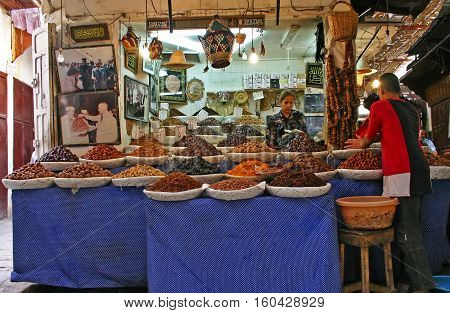 FEZ MOROCCO - MAY 19 2006: Shop selling dried fruit nuts and other foods in the ancient medina Fes el Bali in Fez Morocco.