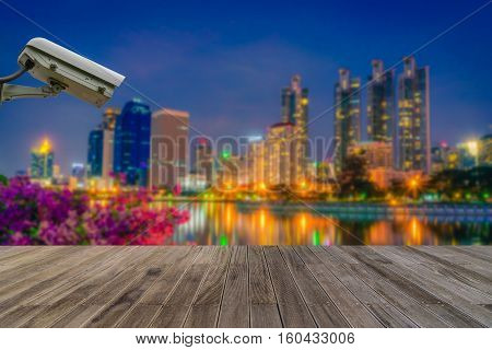 Closed Circuit Television camera monitoring of Benchakitti Park at night sky in Bangkok Thailand.