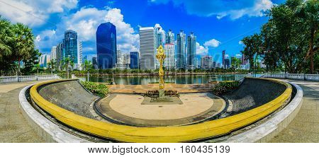 Cityscape image of Benchakitti Park at blue sky background in Bangkok Thailand.