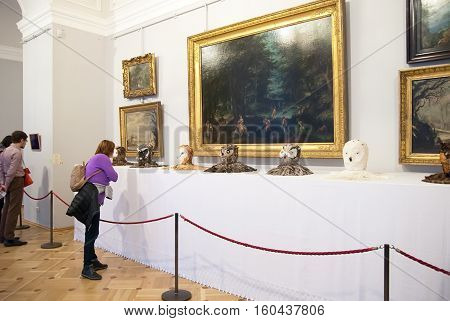 St Petersburg, Russia, Dec 1, 2016: People look at the stuffed heads of owls near painting in Hermitage  Exhibit of temporary modern art exhibition 