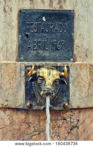 Teruel Spain. - September 15 2015: El Torico fountain in Plaza Carlos Castel. Closeup of the fountain with metal bull head.