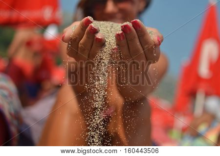 hourglass in the hands of women on summer day.