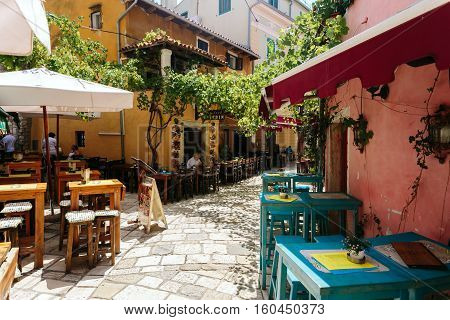Porec, Croatia - July, 2016 - Empty tables of European cafe on a street in the historic center of Porec, Croatia