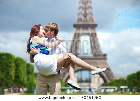 Man Carrying His Girlfriend In His Arms In Paris