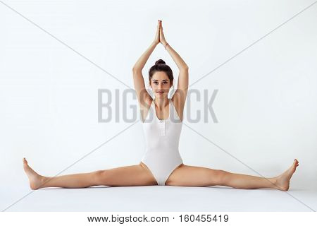 Young Woman Doing Yoga Asana Samakonasana
