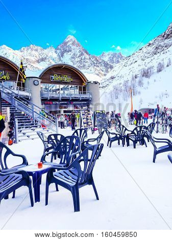 Chamonix, France - January 24, 2015: Restaurant, skiers and snow mountain peaks at Les Grands Montets ski area near Chamonix, France