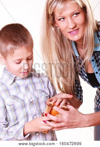 Boy With Mother Hold Sling Shot And Mandarine.