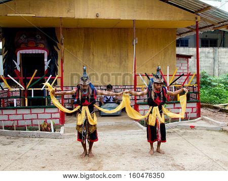 BATAM INDONESIA - DECEMBER 7 2012: Local citizens performing acts in traditional attire during the day