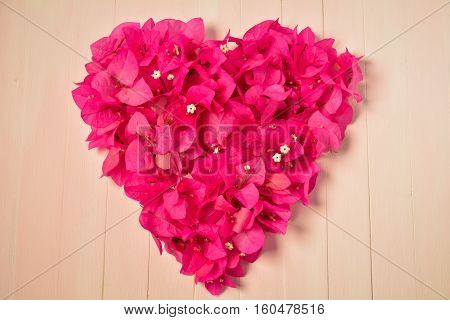 Bougainvillea heart on wood background, valentine day.
