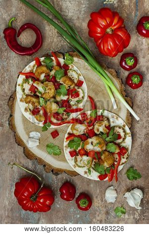 Spicy veggies tacos with roasted cauliflower zucchini and tomato salsa on rustic wooden cutting board. Preparing healthy lunch vegetarian snack. Top view overhead flat lay