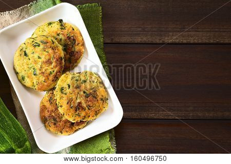 Zucchini couscous and parsley fritters photographed overhead with natural light (Selective Focus Focus on the top of the fritters)