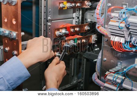 Electrician near the low voltage cabinet. Uninterrupted power supply. Electricity.