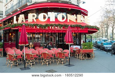 Paris France-December 05 2016: The famous cafe La Rotonde decorated for Christmas located on Montparnasse boulevard in Paris.It was once home for to intellectual stars from Hemingway to Picasso.