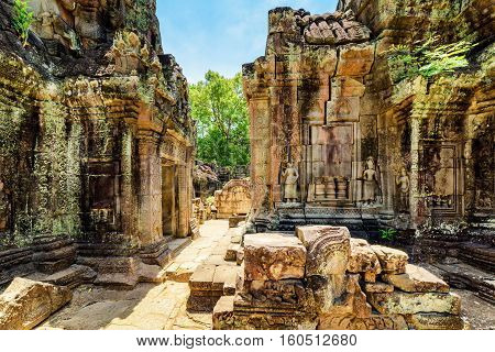 Ancient Mossy Buildings With Carving Of Ta Som Temple In Angkor