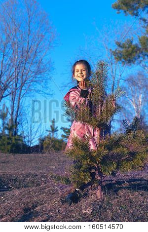 the girl sends a kiss for little Christmas tree
