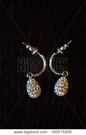 earrings on black wooden background without reflection