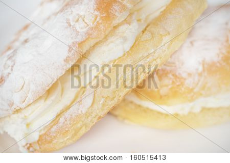 Delicious cream pastry macro picture selective focus on the cream.