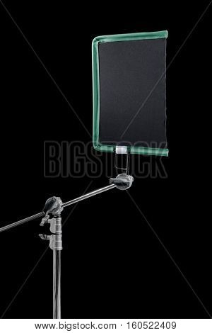 Film lighting equipment: A single scrim mounted on a c-stand.