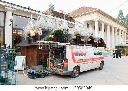 BADEN-BADEN GERMANY - DEC 2 2016: Woman walking toward Peters Cafe the leading Cafe chain in Baden-Wurtemberg land in Kurhaus Colonnades