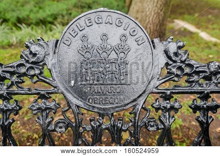 Mexico City, Mexico - July 6, 2013: Park bench beside the Monument to Alvaro Obregon (Monumento a Alvaro Obregon) in Parque de la Bombilla.