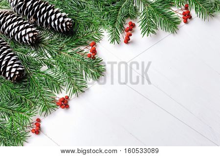 Christmas New Year composition with tangerines, cones, nuts, wicker basket and fir branches in rustic style on old wooden background, selective focus, Background new year, fir, gift, cones, orange, blue ball, red background, snow, ,