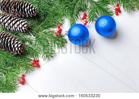 Christmas New Year composition with tangerines, cones, nuts, wicker basket and fir branches in rustic style on old wooden background, selective focus, Background new year, fir, gift, cones, orange, blue ball, red background, snow, ,