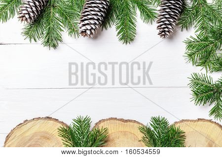 Christmas New Year composition with tangerines, cones, nuts, wicker basket and fir branches in rustic style on old wooden background, selective focus, Background new year, fir, gift, cones, orange, blue ball, red background, snow, ,