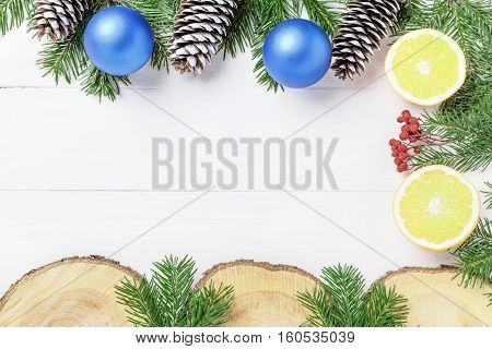 Christmas New Year composition with tangerines, cones, nuts, wicker basket and fir branches in rustic style on old wooden background, selective focus, Background new year, fir, gift, cones, orange, blue ball, red background, snow, ,