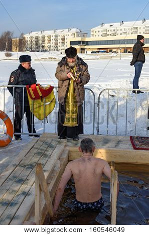 Priest Consecrates The Ice Hole On Epiphany Day. Russia