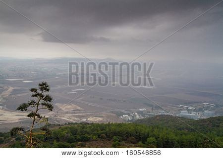 View of the Jezreel Valley in fog in winter cloudy day from Muhraqa on Mount Carmel in Lower Galilee Israel