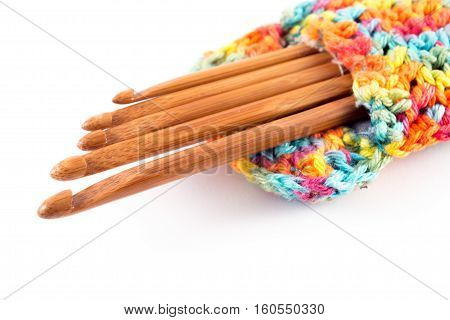 Wooden crochet hooks in crochet bag isolated on white background