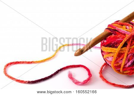 Crochet hook and yarn ball isolated on white background