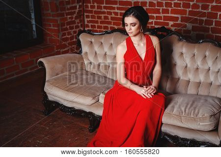 Portrait of Beautiful Sensual smilyng Woman in Fashion Red Dress. Christmas Sales and Shopping concept. Studio shot