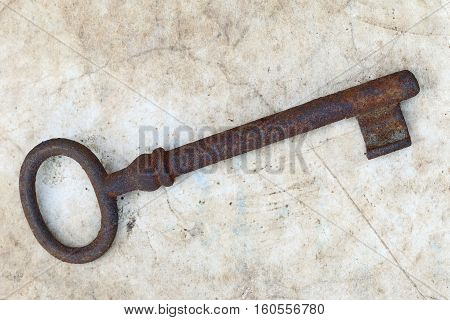 Detail of the rusty key on old parchment