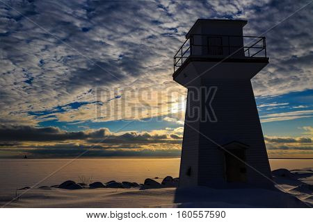 Lighthouse or range light along the waterfront of Summerside, Prince Edward Island at sunset.