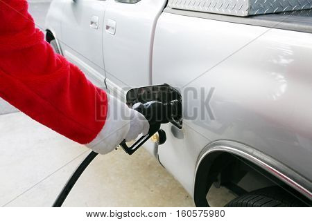 Santa Claus Gas Station Fill up. Santa refuels his truck before Christmas eve. 