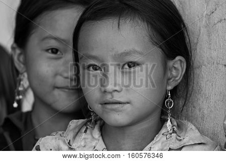 MU CANG CHAI, VIETNAM - SEP 20, 2010: Unidentified Vietnamese minority children looking at the visitor's camera at the play ground of their school.
