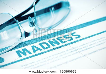 Madness - Printed Diagnosis on Blue Background and Glasses Lying on It. Medicine Concept. Blurred Image. 3D Rendering.