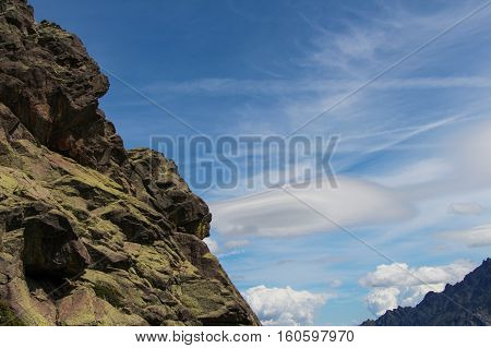 Close up of the mountain with clouds on background.