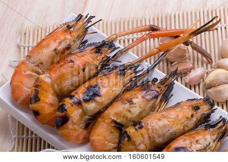 Burn Shrim And Seafood Sauce On Wooden Table.