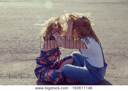 Relations of sisters. Sisters play with each other