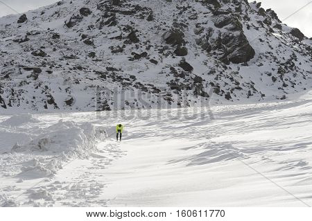 young healthy sport man running in snow mountains in trail runner hard workout in energy and endurance concept with a beautiful cold winter background