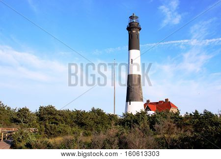 The Fire Island Lighthouse with a deep blue sky behind it