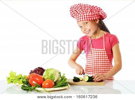 Little girl preparing fresh salad isolated on white