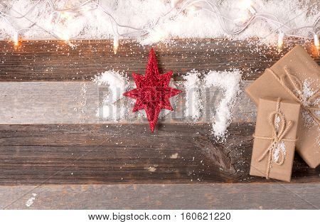 Christmas decoration and gifts. Happy New Year 2017 greetings on wooden instead of zero star.