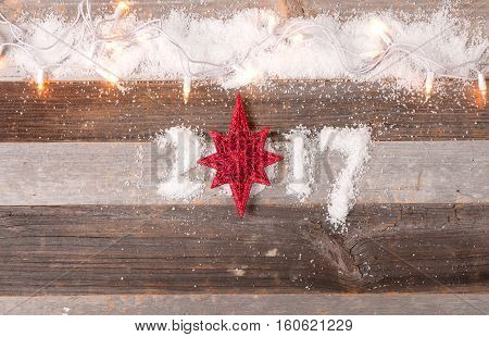 Happy New Year 2017 greetings on wooden instead of zero star. Christmas decoration