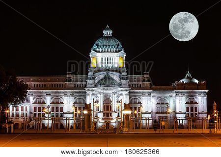 The Ananta Samakhom Throne Hall (Phra Thinang Anantasamakhom) in Thai Royal Dusit Palace with super moon in the night time Bangkok Thailand.