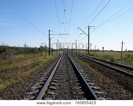 Double-track electrified railroad goes into the distance.