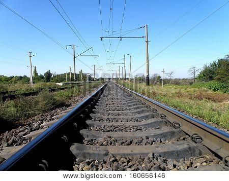 Double-track electrified railroad goes into the distance.
